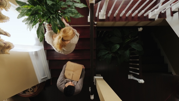 A Young Multiracial Couple Is Resettled in a New House They Carry Their Things Upstairs, a alt