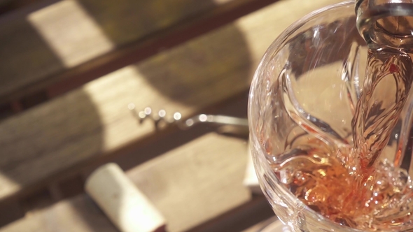 the Wine From the Bottle Neck Flows Into the Glass on the Table