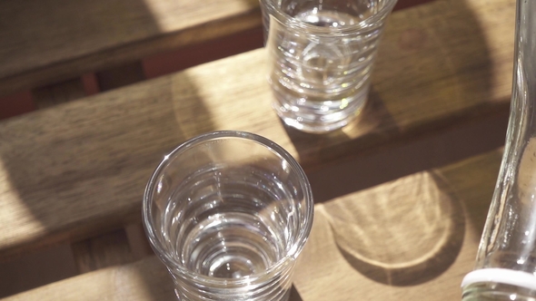 Vodka Is Poured Into a Glass From a Bottle