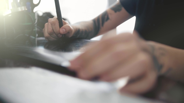 Designer Draws on a Graphic Tablet. . alt