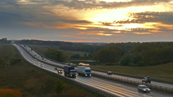 Cars Traveling on the Highway Road at Sunset, alt