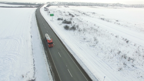  Truck Driving Winter Road in Snowy Field