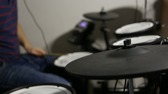 Drummer Playing at the Electronic Drums Kit