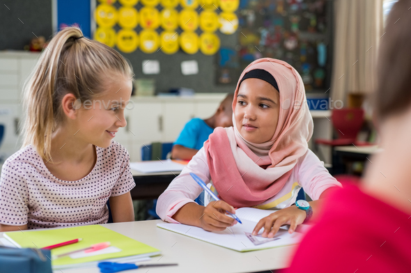 Muslim girl with her classmate - Stock Photo - Images