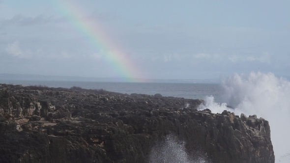 Wild Waves Breaking in the Atlantic Coast with Rainbow in
