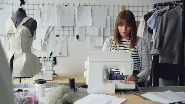 Professional Female Tailor Is Adjusting Sewing Machine alt