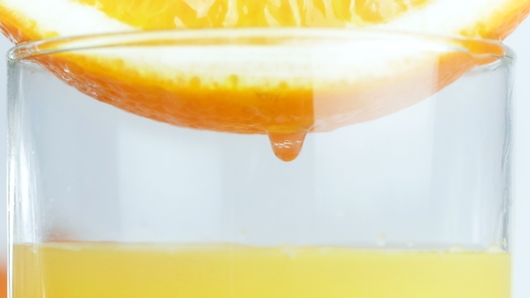 Video of Juice Orange Slice in Glass. Drops of Juice Falling Down alt