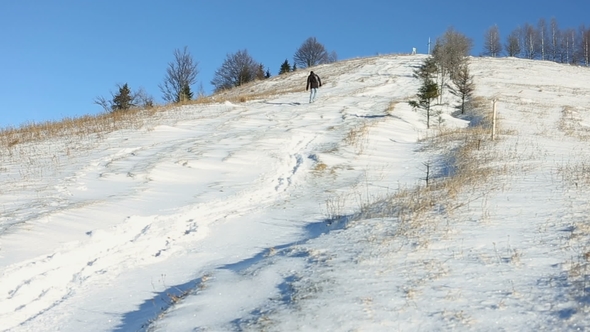 Man Goes To Snowy Mountain at Winter