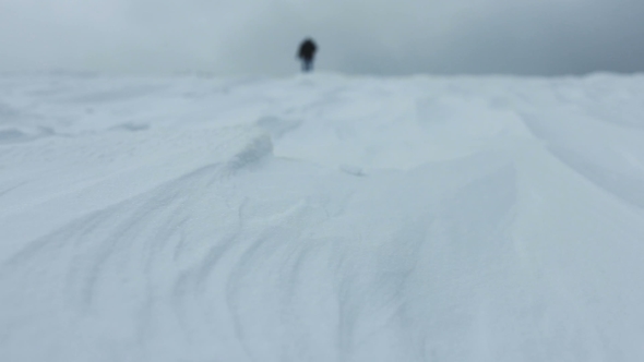 Man Goes Through the Snow at Mountain