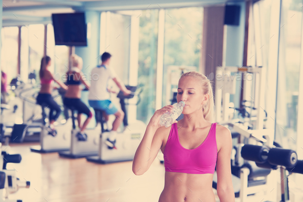 woman in fitness gym drink water