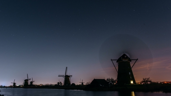 Amazing Milky Way and Thousands of Shiny Stars Over Old Windmills in Netherlands. Beauty of Holland