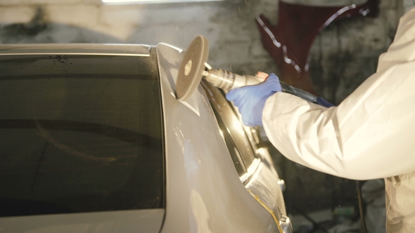 The Grinding Primered Car Surface with Grind Machine. alt