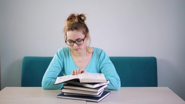 Tired, Angry, Exhausted Student Lowered Her Head on a Stack of Books. You Have To Read a Lot of