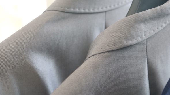 Male Business Clothes on a Hanger in the Store alt