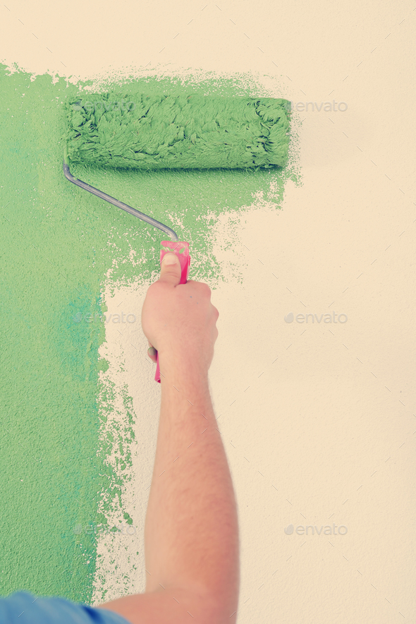 handsome young man paint white wall in color Stock Photo by dotshock