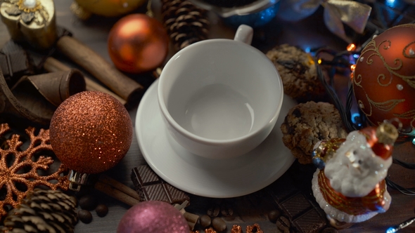 Cup of Hot Coffee with Cinnamon Sticks on Wooden Table Among Christmas Decorations
