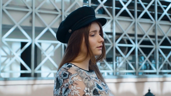 Girl with Long Hair Walking along the Street