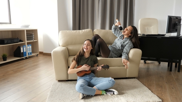 Two Sisters in the Living Room Having a Good Time alt