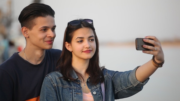 Happy Girl Takes a Selfie with Her Young Boyfriend on the Dnipro Bank