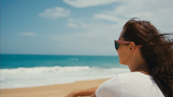 Woman Sitting On The Beach