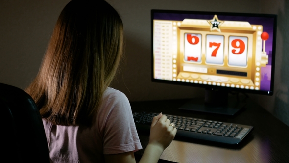 A Young Woman Playing in an Online Casino Has Won a Jackpot. Brunette Presses on the Keyboard and