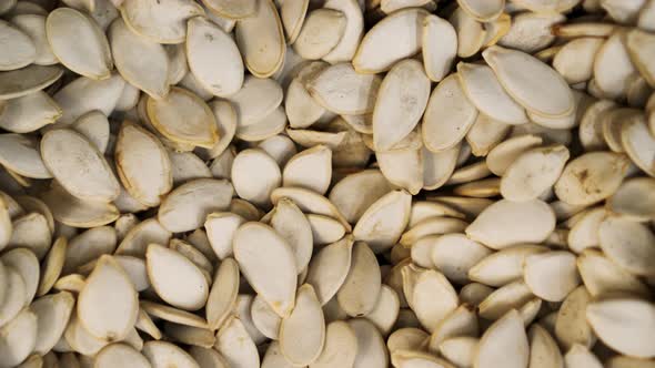 Many Pumpkin Seeds Close Up Panning Against the Background in a  Store. alt