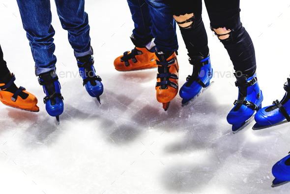 Feet closeup of group of friends ice skating together Stock Photo by Rawpixel