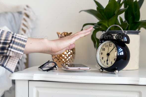 Woman reaching hand out to turn off the alarm Stock Photo by Rawpixel