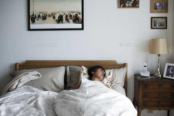 Senior woman sleeping alone on the bed Stock Photo by Rawpixel | PhotoDune