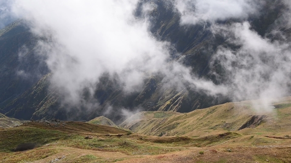 Rapid Floating Clouds over Grassy Autumn Mountain Hill at Upper Svaneti