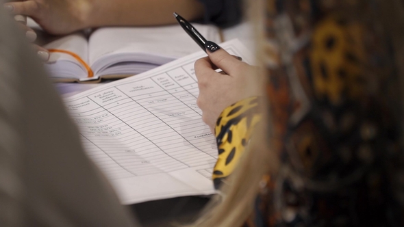 Employees Are Making Notes in a Notepad