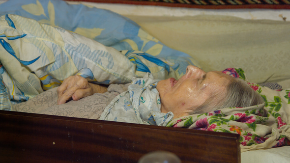 Sick Old Woman Laying in Bed alt