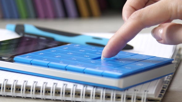 Women's Hand Presses on the Keys of the Calculator alt