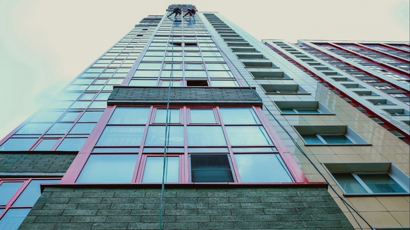 Glass on a High-rise Building, Two Men Wash the Windows on a High-rise Building alt