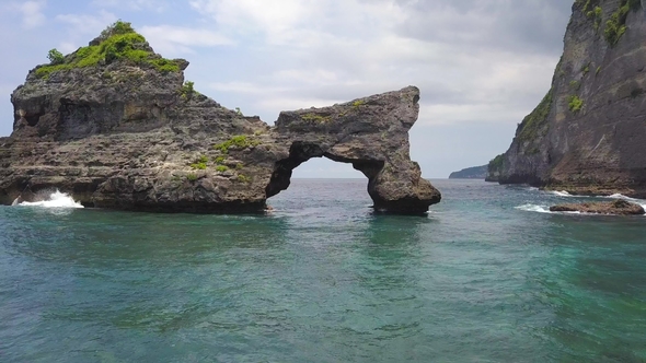 Amazing Rock Arch Island in the Sea at Atuh Beach in Nusa Penida, Indonesia.  