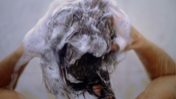 Woman Washing Her Hair with Shampoo. .