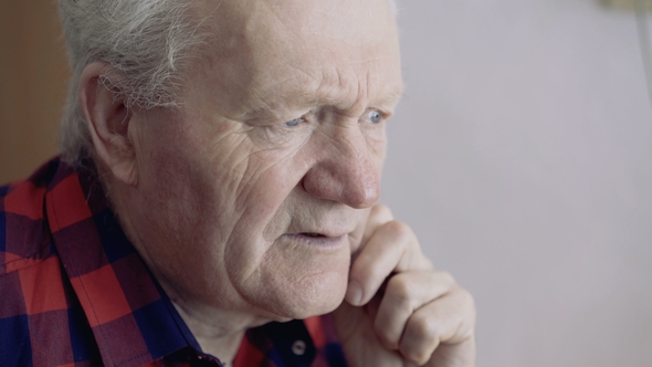 Portrait of Old Man Looks at Window with Thinks Then Smiles at Camera alt