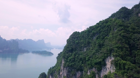 Limestone Rocks Rising From Water. Top View of Mountains in Khao Sok National Park alt