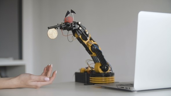 Funny Robot Extracts Bitcoin. Experiment with Intelligent Manipulator. Industrial Robot Model with alt