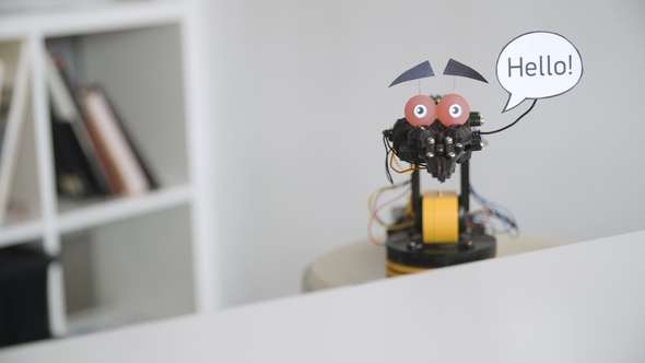 Funny Robot Says HELLO. Experiment with Intelligent Manipulator. Industrial Robot Model with Funny alt
