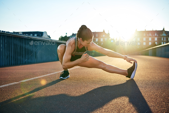 Sun highlights young muscular female athlete - Stock Photo - Images