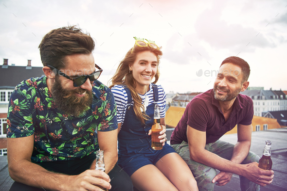 Three happy companions drinking together - Stock Photo - Images