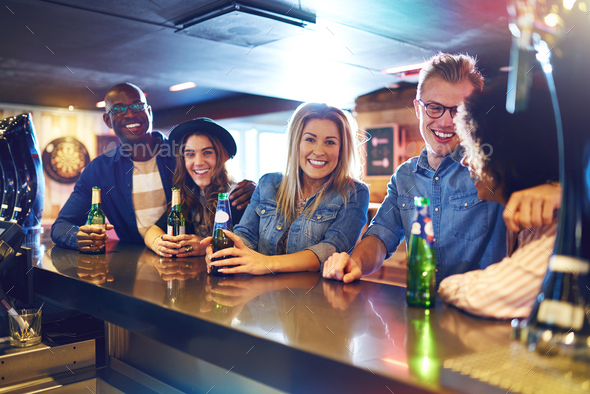 Happy group of people drinking in bar - Stock Photo - Images