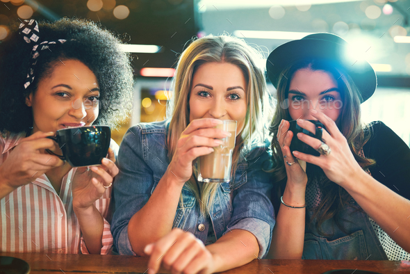 Young women sipping coffee Stock Photo by UberImages | PhotoDune
