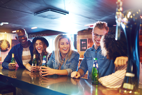 Group of happy people at bar counter - Stock Photo - Images