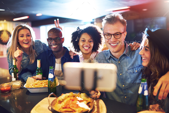 People in bar doing selfie and smiling - Stock Photo - Images