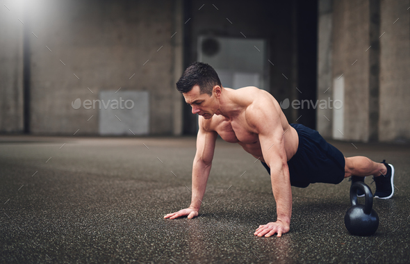Full length shot of man doing push-ups - Stock Photo - Images