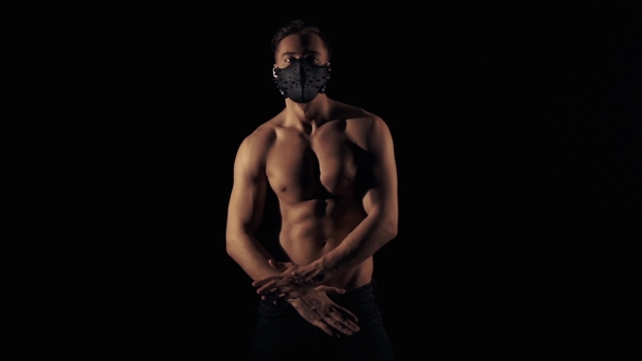 Man in Mask Is Posing in a Flashing Light