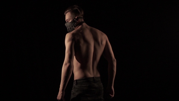 Man in Mask Is Posing in a Flashing Light