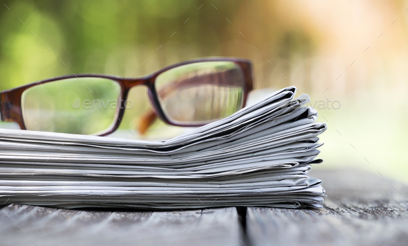 Morning news concept - newspaper and glasses Stock Photo by Elegant01